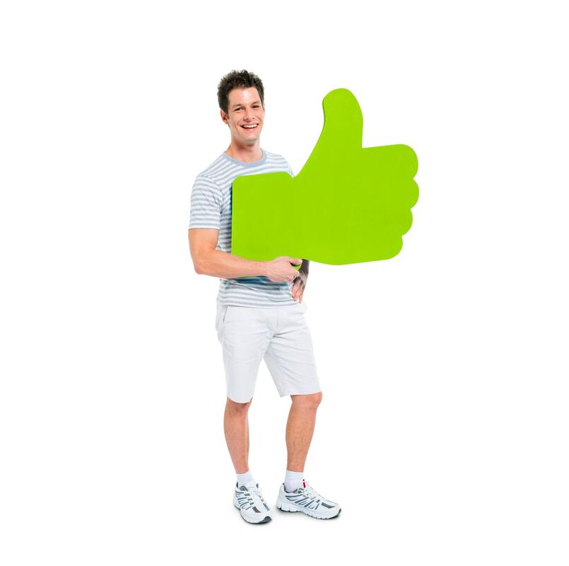 A man wearing a t-shirt and shorts is holding a green thumbs up sign and smiling in a friendly way. He is tall, handsome and athletic.